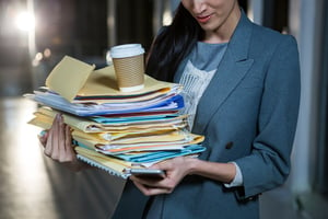 Business woman carrying paper visitor log files