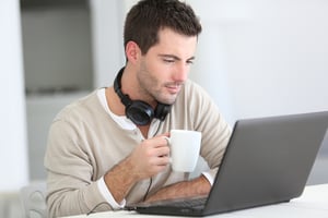 Coworking space member enjoying coffee while working