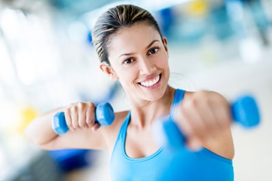 Women exercising in her shared workspace's gym room