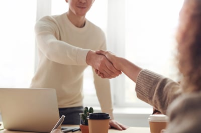 Employee shaking hands with a walk-in customer
