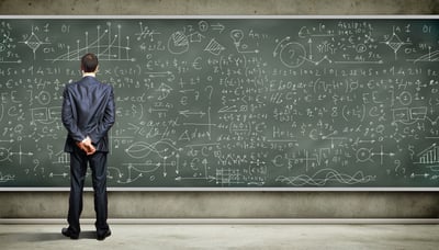 Man in a suit reviewing complex calculations