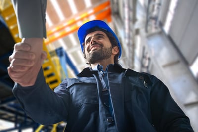 Facilities manager shaking hands with a coworker