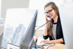 Female employee receiving host notification from a visitor management system