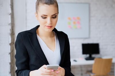 Receiving Slack visitor notifications on her smartphone