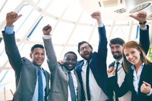 Employees in formal attire cheering