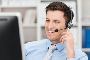 Receptionist smiling while talking on the phone