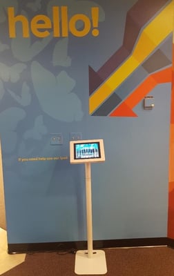 Digital visitor management system kiosk in a reception area