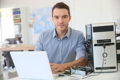 Facilities manager fixing a desktop computer