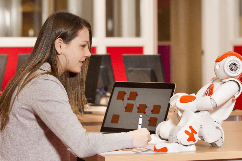 Woman working with visitor management robot