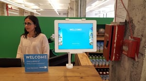 Receptionist using visitor management software