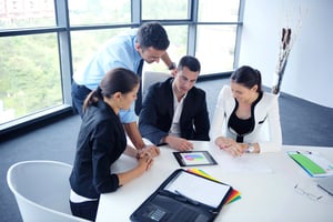 Workers collaborating in a modern office conference room