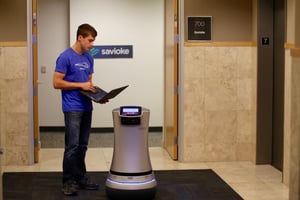 Man working with an office automation robot in an elevator bank