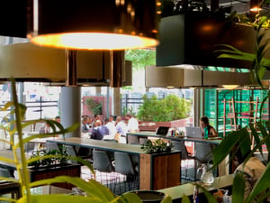 People working in a cafe and patio space at Open coworking in Johannesurg