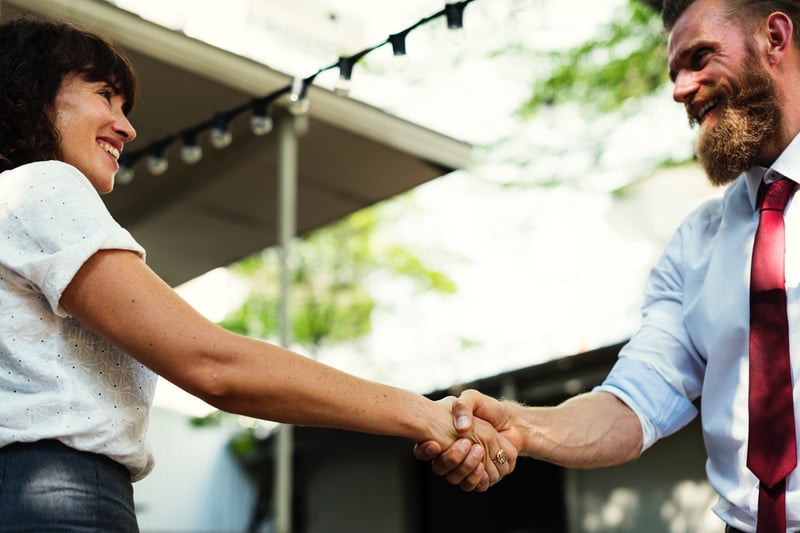 Young businessman shaking hands with a mentor