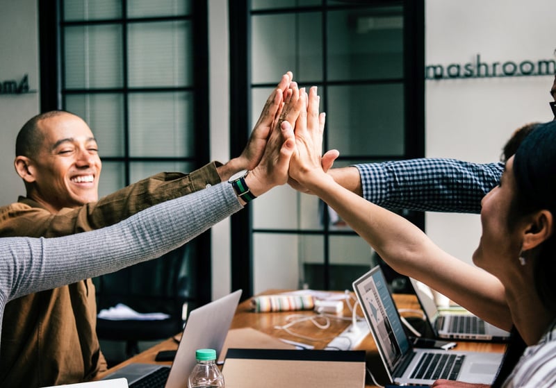 Worker celebrating in a coworking space
