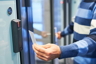 Touchless scanning an employee badge to open an office door