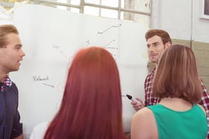 Team of young employees reviewing data and making decisions