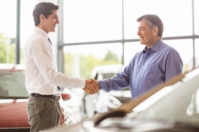 Employee shaking hands with a visitor in the reception area