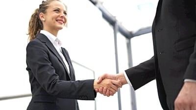 Handshake in office reception area