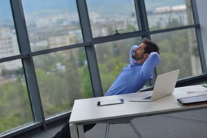 Worker enjoying the view from his executive office suite