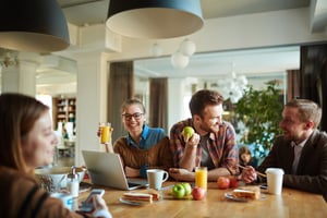 Workers socializing and snacking in a modern coworking space