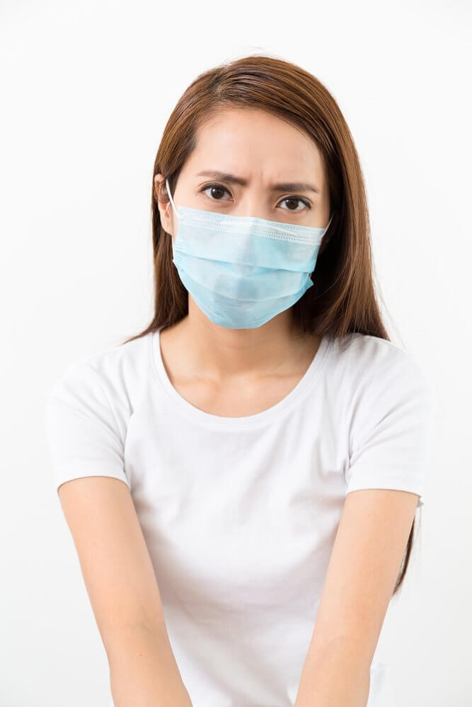 Employee wearing a mask to use visitor sign in system