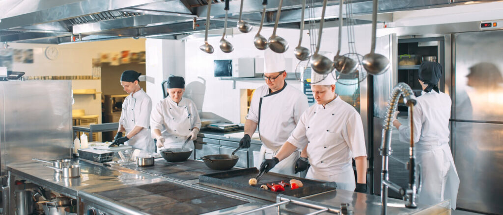 Chefs and staff cooking together in the kitchen