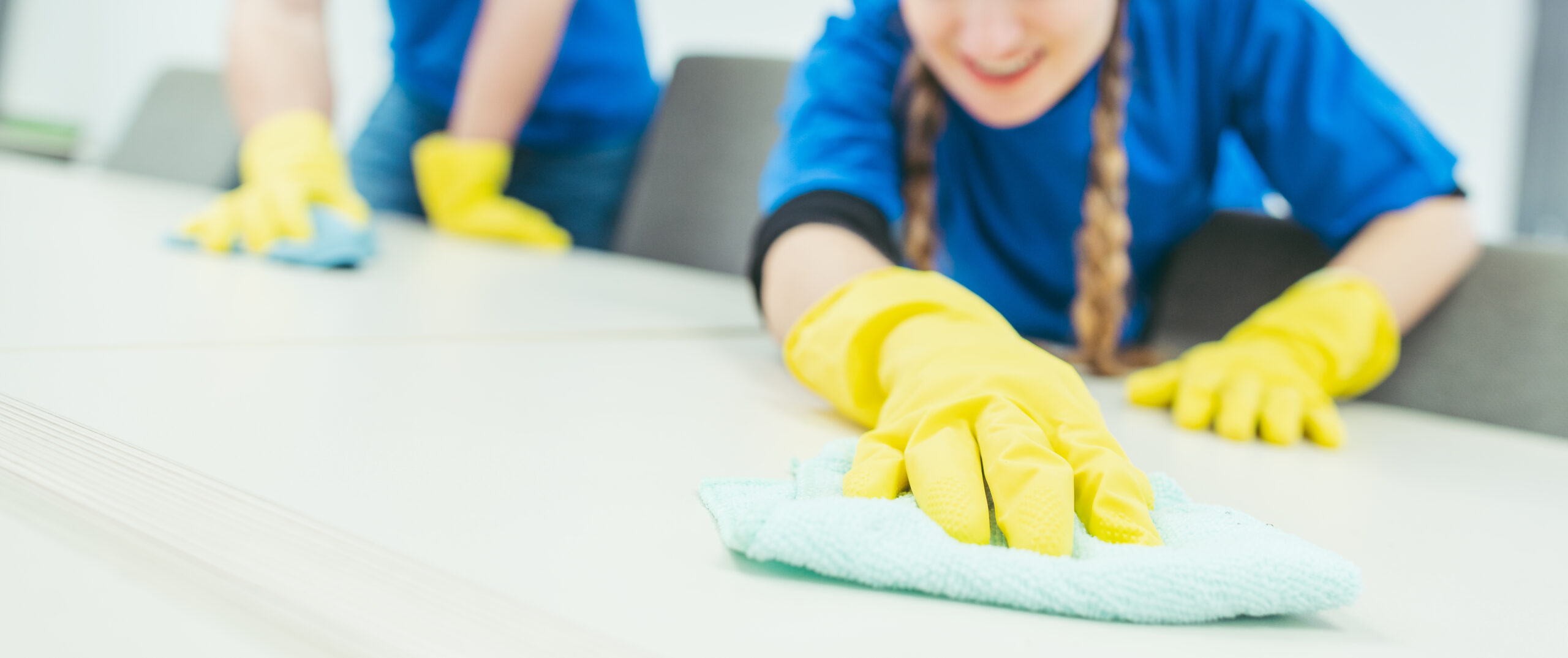 Close-up of cleaning team working in an office Close-up of cleaning team working in an office, banner cut