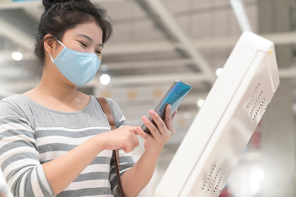 Visitor using a touchless check-in app