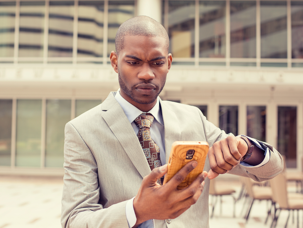 Employee using phone to mark himself safe after a workplace emergency