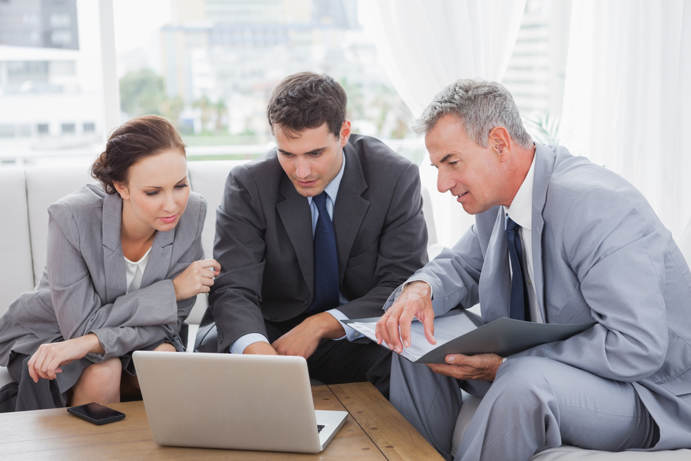 Business,People,Working,Together,On,Their,Laptop,In,Cosy,Meeting