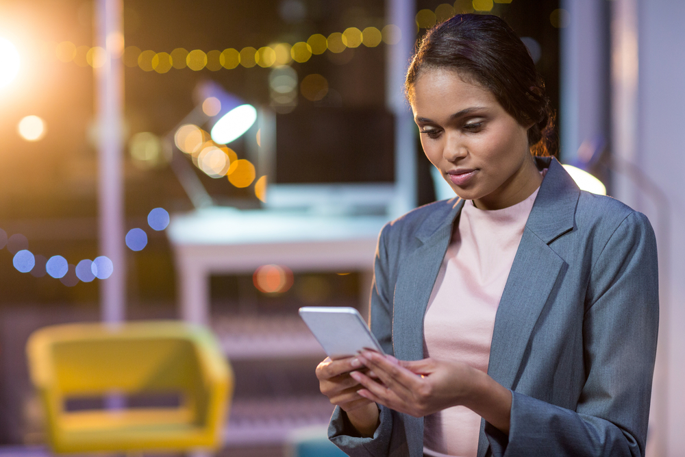 Business woman receiving a notification from her visitor management system